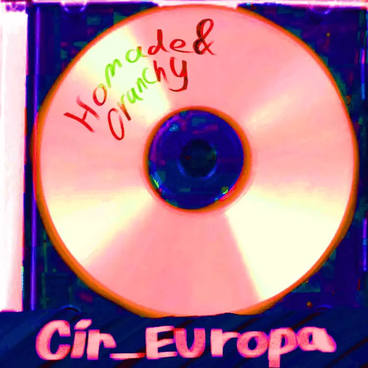 A CD in a transparent CD case flashing through pink, orange and yellow. &quot;Homemade & crunchy&quot; is written along the curve of the CD. At the bottom of the case, &quot;Cir_Europa&quot; is crudley written in marker over black tape.